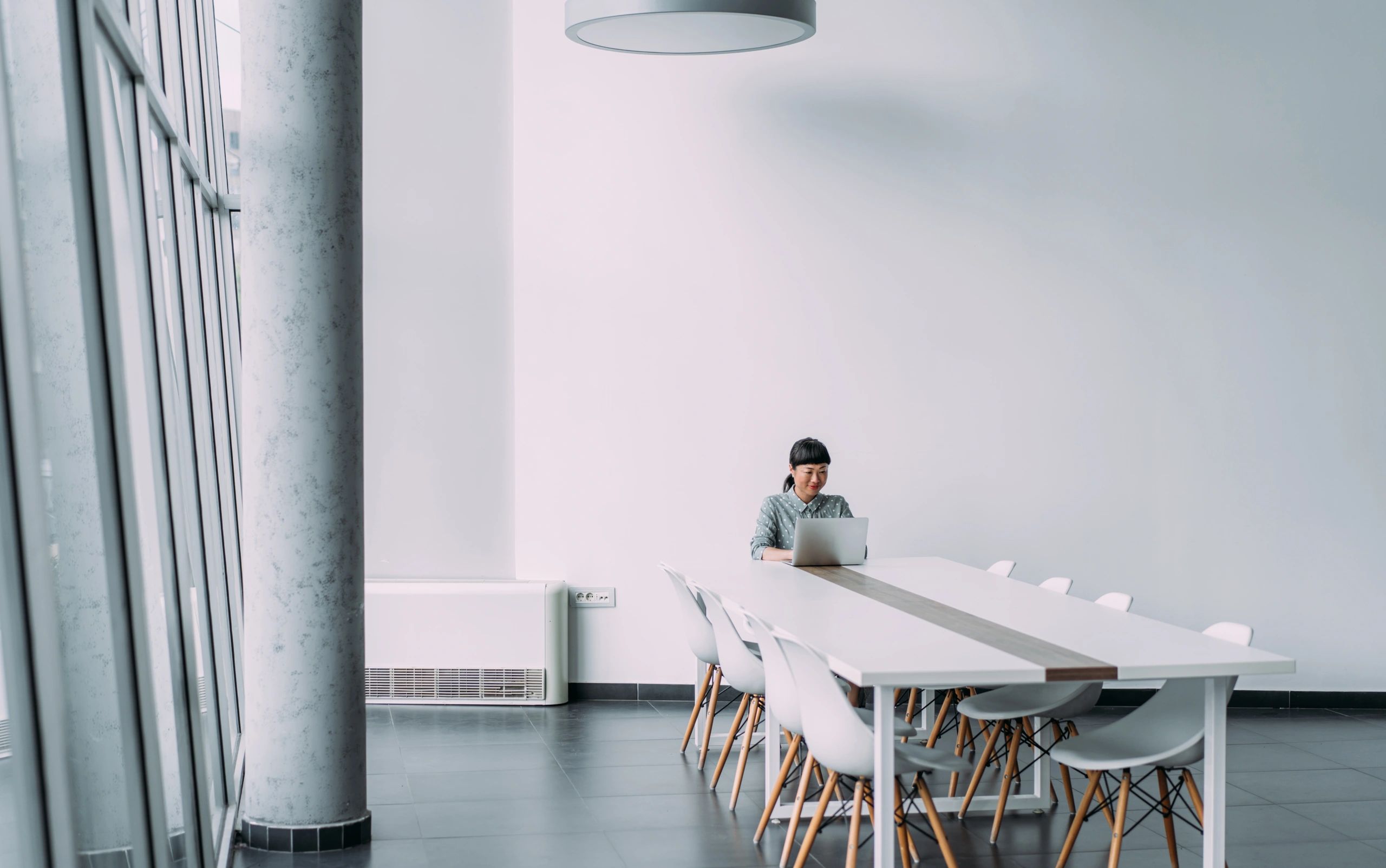 Consultant working in a modern office on a laptop